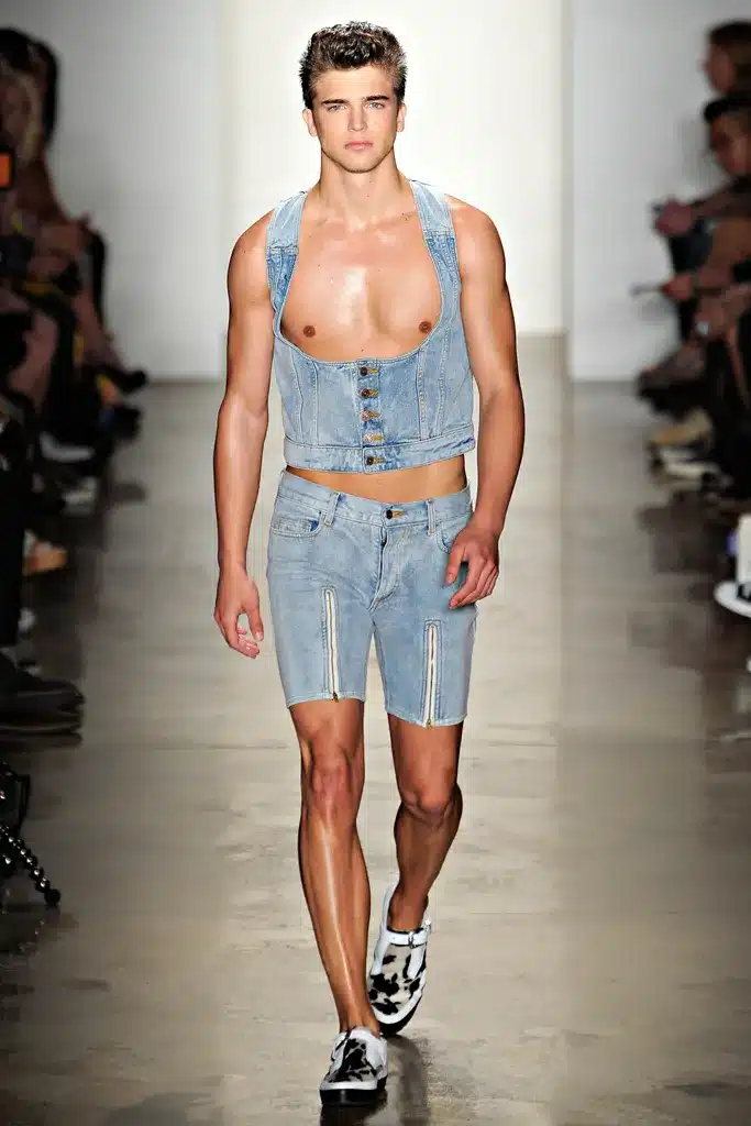 A man in blue shorts and tank top on runway.