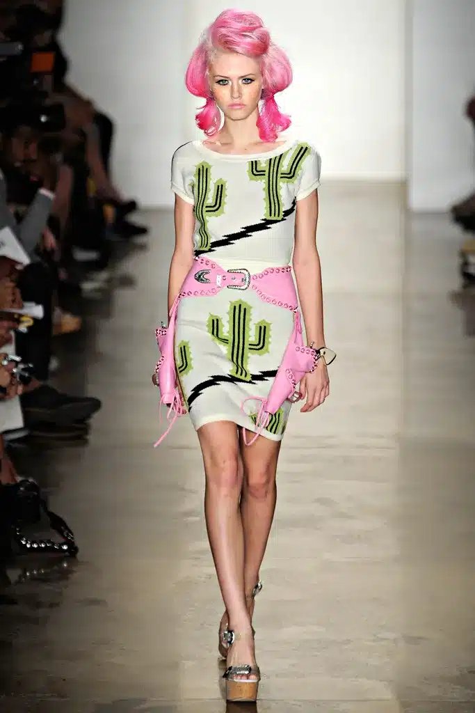 A model walks the runway in a cactus print dress.