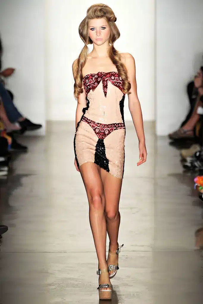 A model walks the runway in a lingerie style outfit.