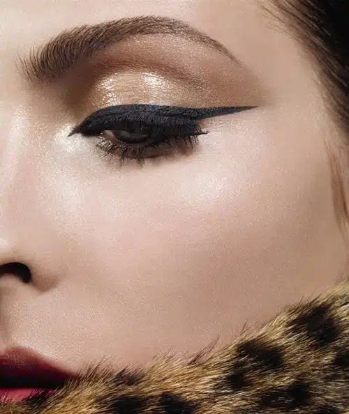 A close up of a woman 's face with cat eyes