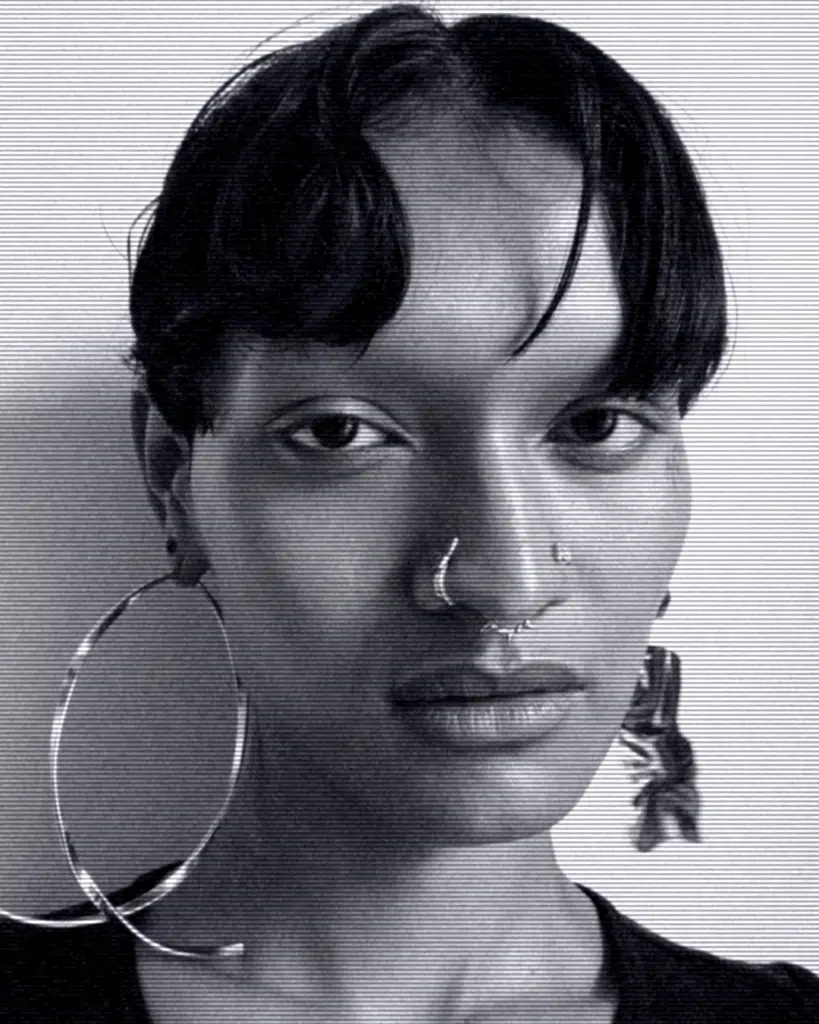 A woman with large nose rings and big earrings.