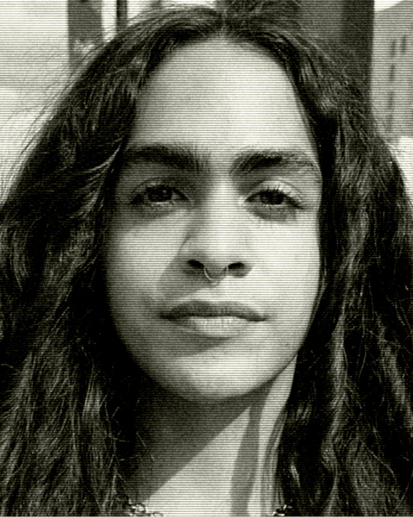 A man with long hair and no shirt.