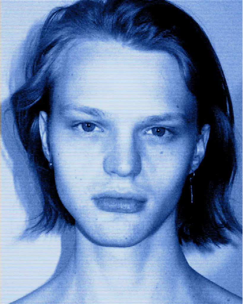 A blue photo of a woman with short hair.