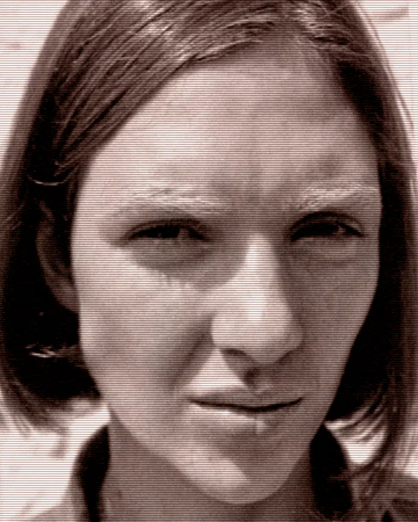 A woman with short hair is looking at the camera.