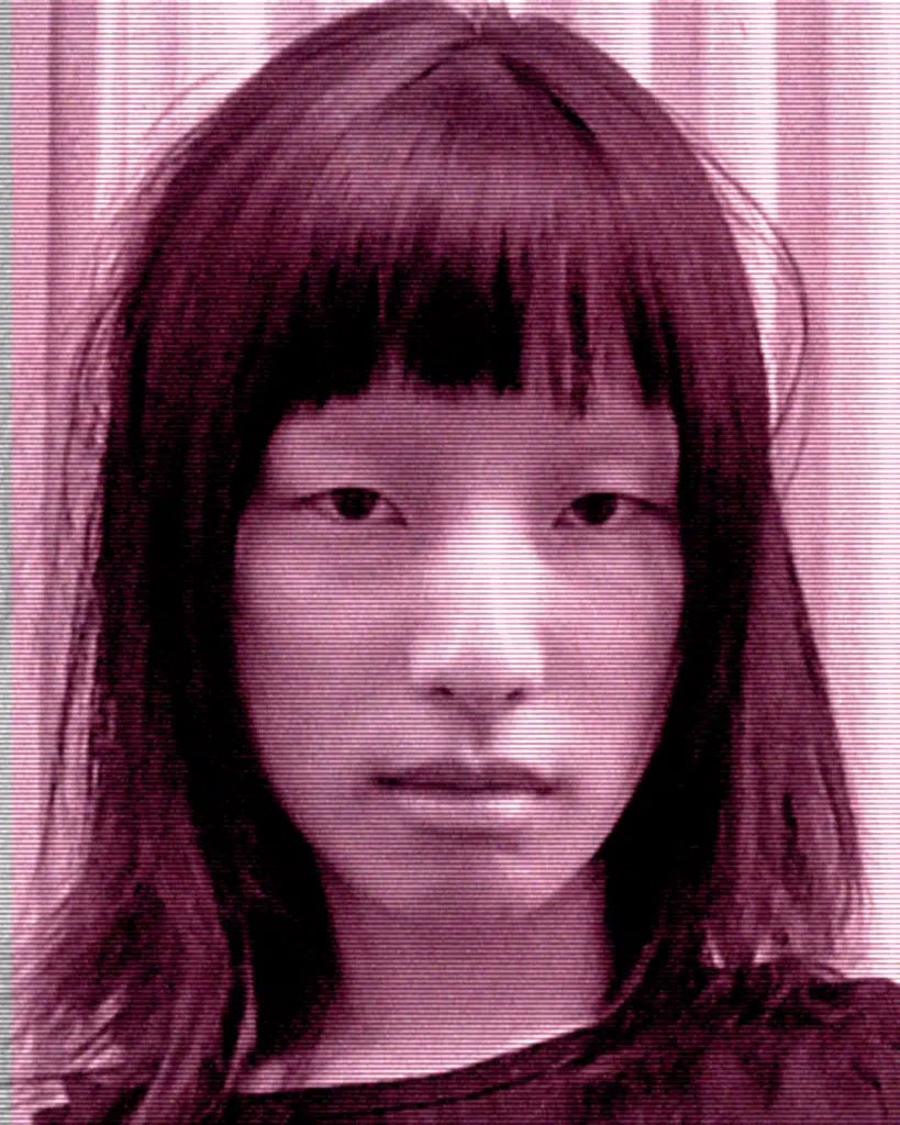 A young woman with long hair and bangs.