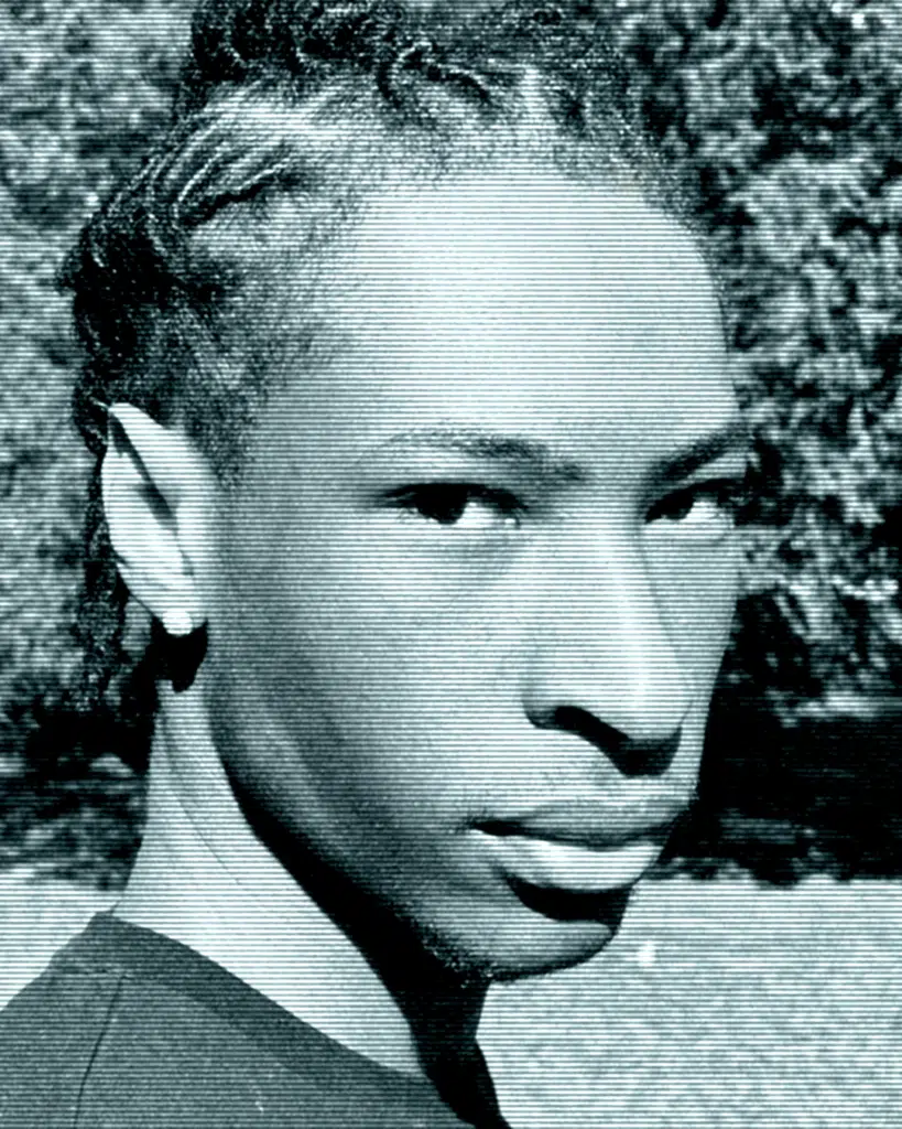 A black and white photo of a man with dreadlocks.