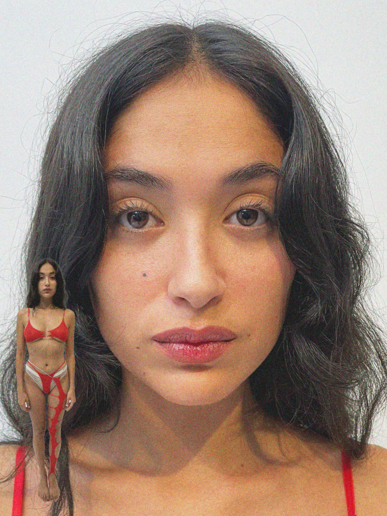 A woman in a red bikini standing next to a doll.