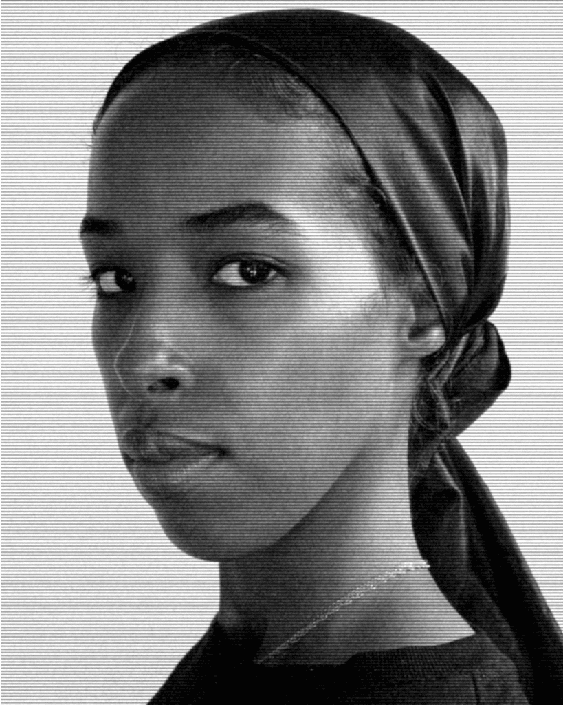 A black and white photo of a woman with a head scarf.