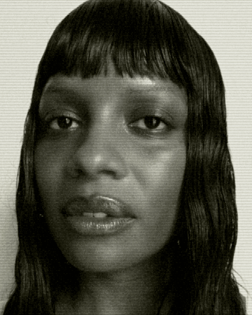 A black and white photo of a woman with bangs.
