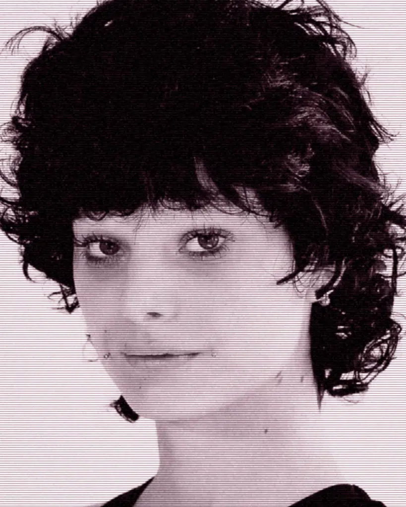 A black and white photo of a woman with short hair.