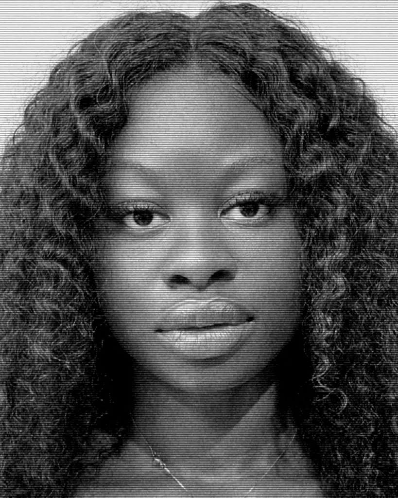 A black and white photo of a woman with long hair.