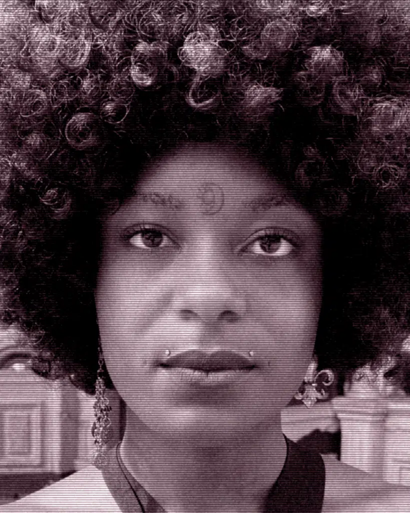 A woman with an afro and a necklace.