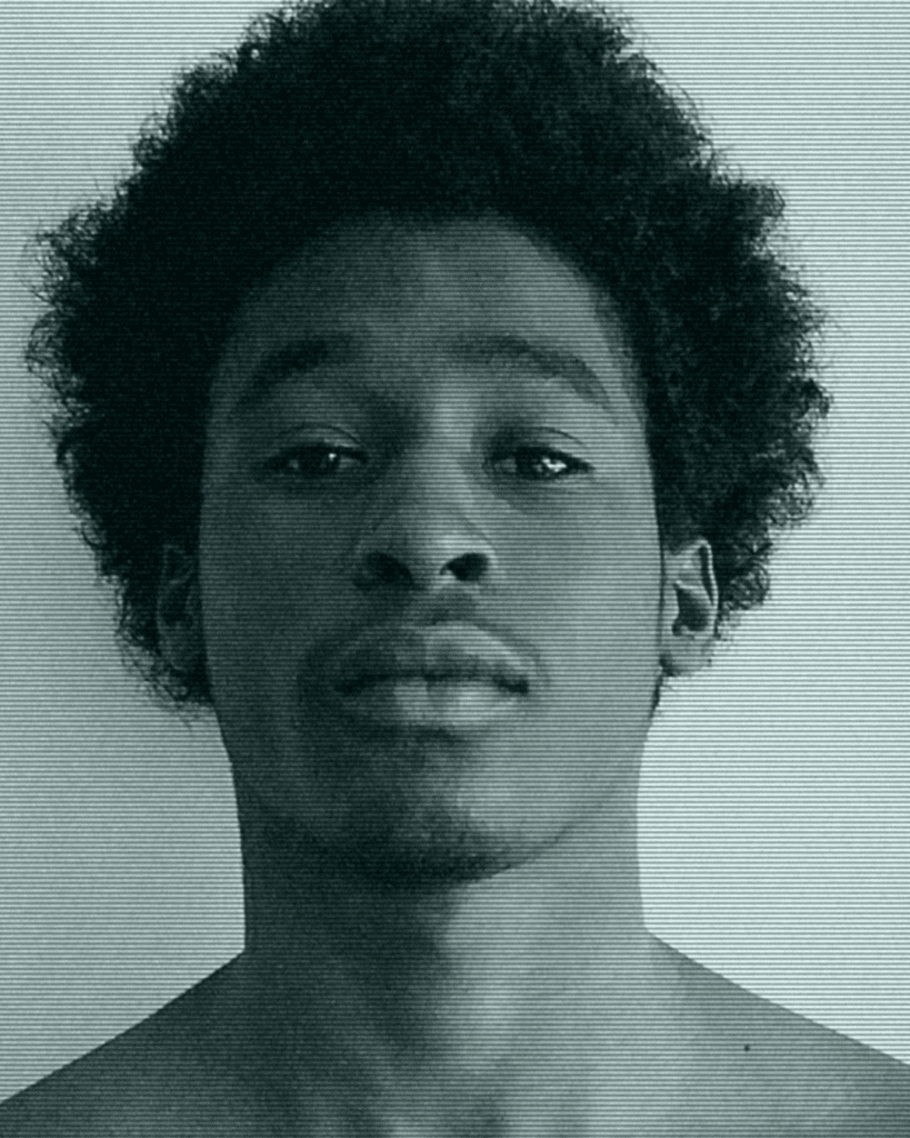 A man with curly hair and no shirt.