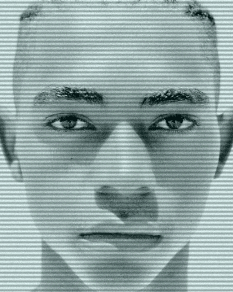 A man with shaved head and short hair.