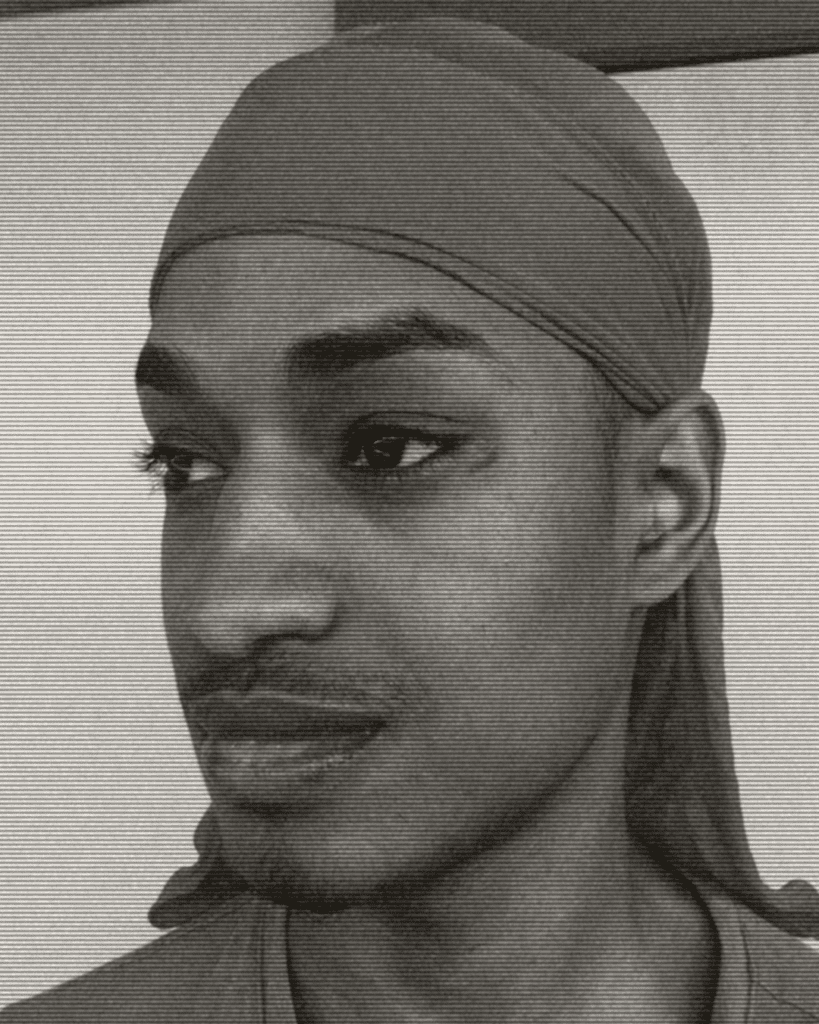 A man with long hair and a head scarf.