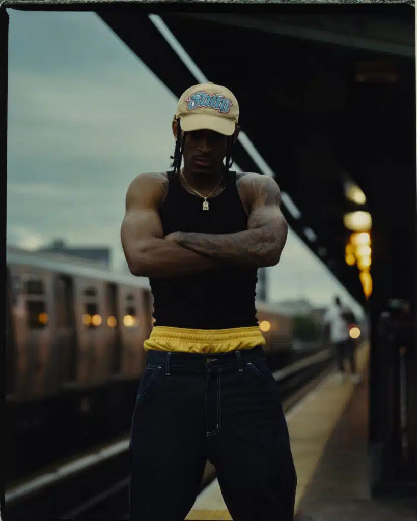 A man standing on the side of a train platform.