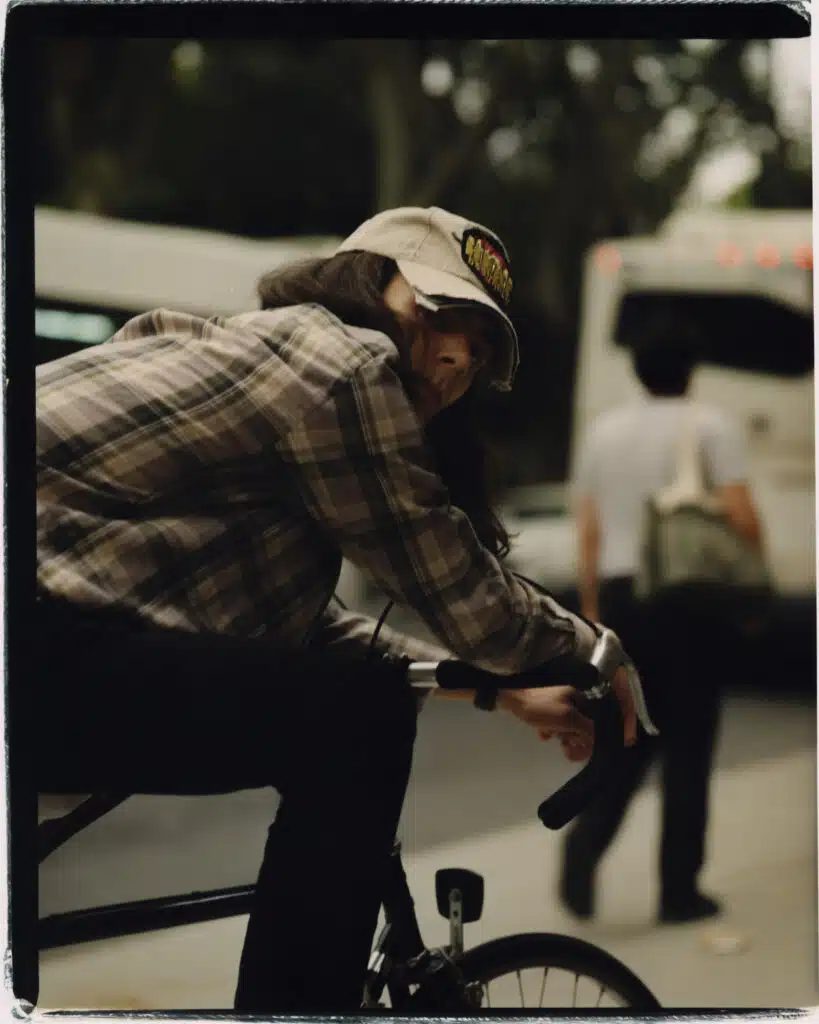 A man riding on the back of a bicycle.