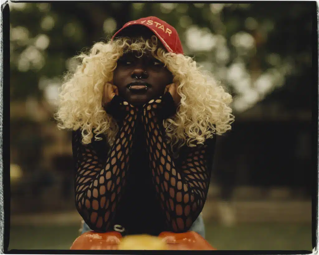 A woman with blonde hair and a red hat.