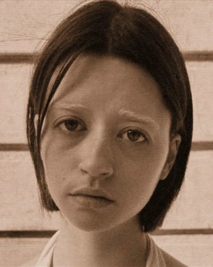 A young girl with long hair and a short haircut.