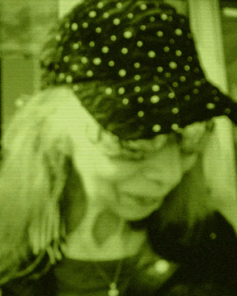 A blurry picture of a woman wearing a hat.