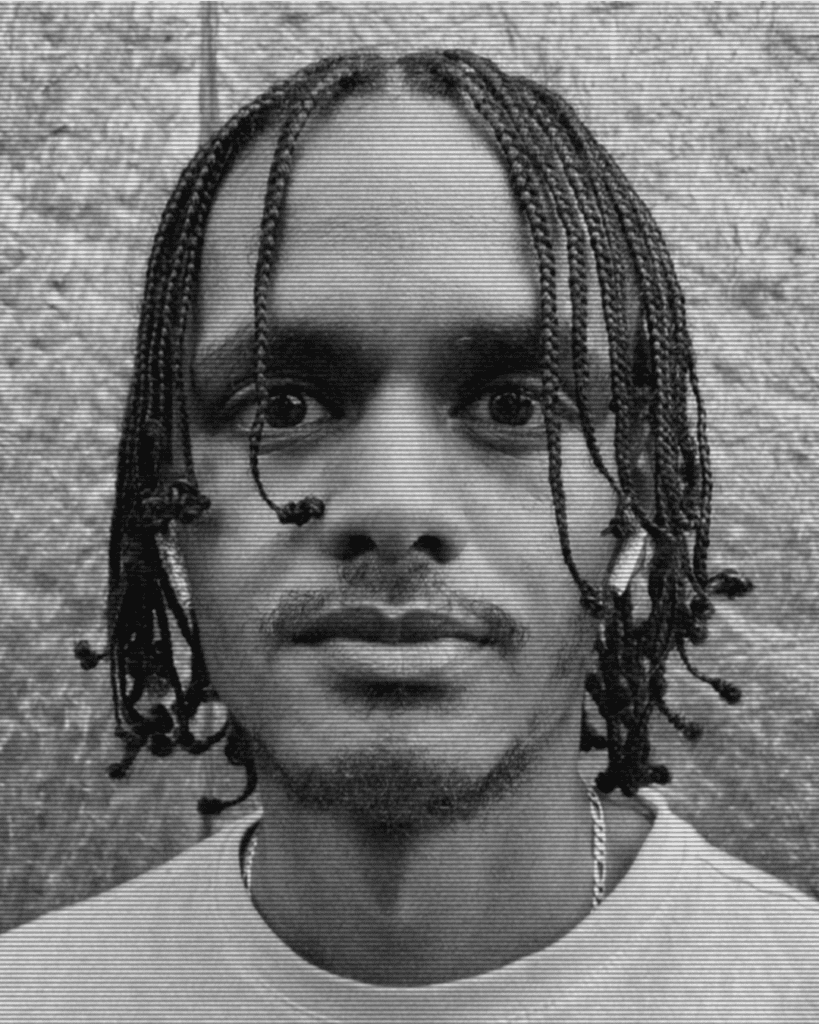 A man with dreadlocks is wearing white shirt.