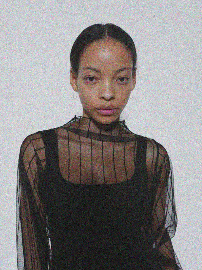 A woman in black shirt and white background