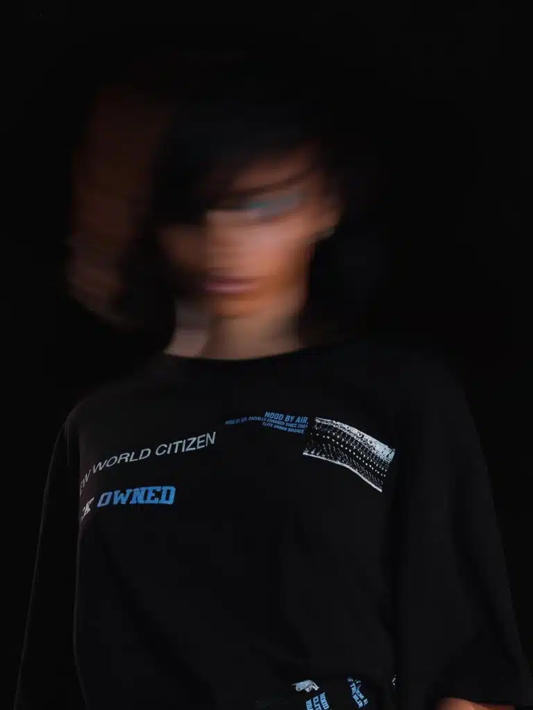 A blurry picture of a person in black shirt