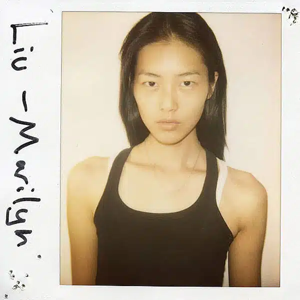 A polaroid picture of a woman with black hair.