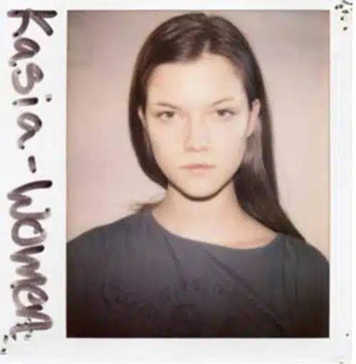 A polaroid picture of a woman with long hair.