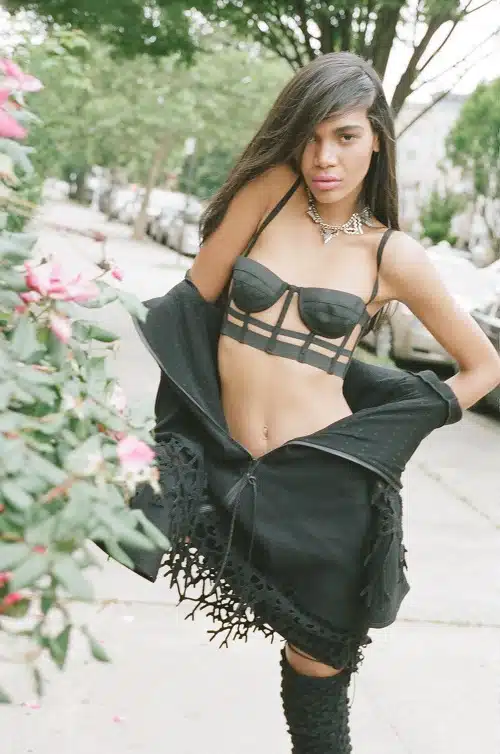 A woman in black lingerie and a black shawl.