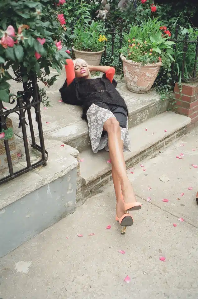 A woman laying on the steps of her house