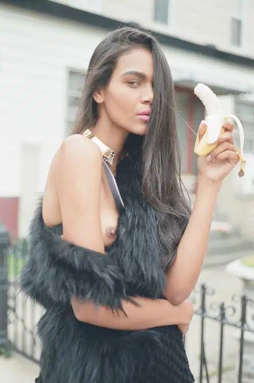 A woman holding a banana in her hand.