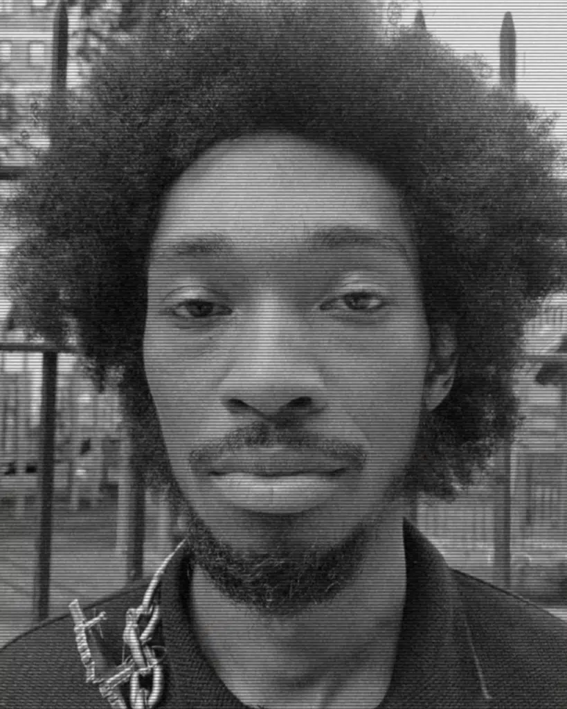 A black and white photo of a man with afro hair.