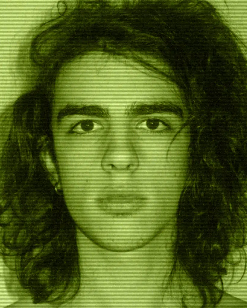 A man with long hair and piercing eyes.