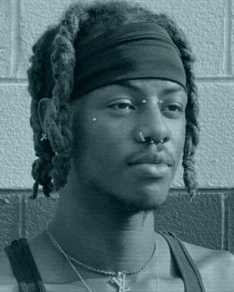 A man with dreadlocks and a bandana on his head.