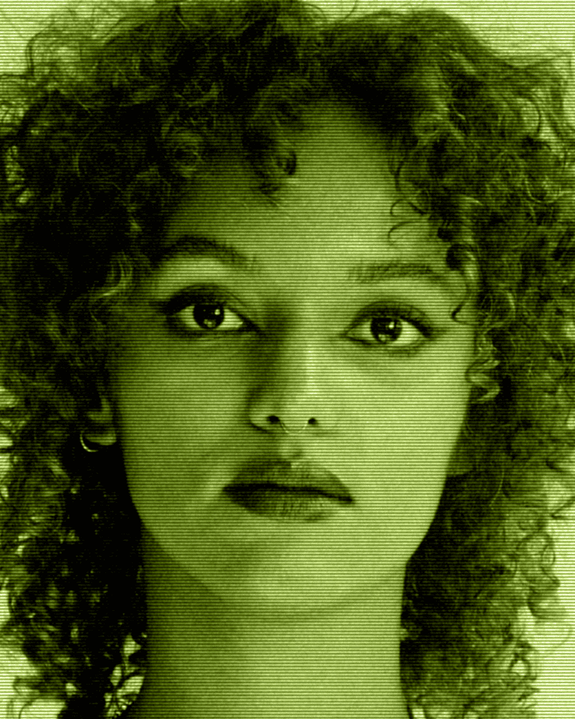 A woman with curly hair and tears in her eyes.