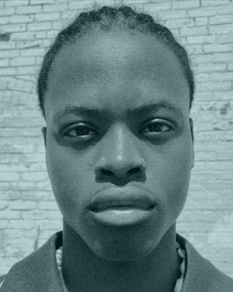 A man with short hair is looking at the camera.