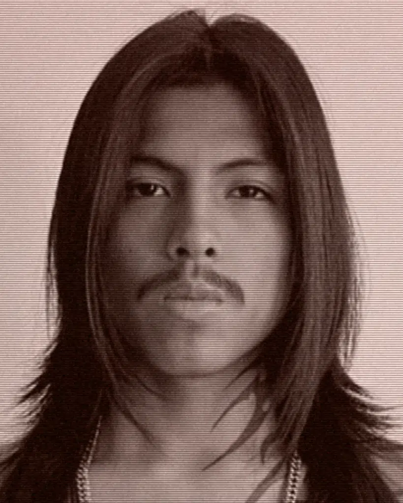 A man with long hair and mustache.