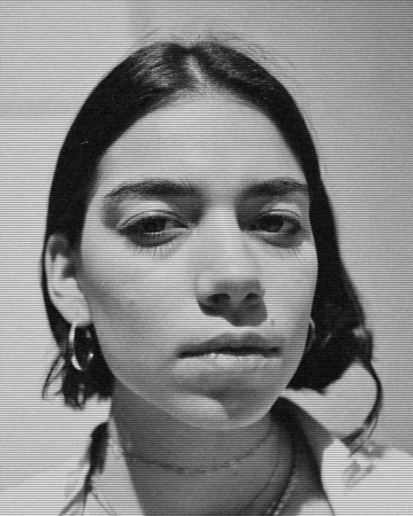 A black and white photo of a woman with a piercing.