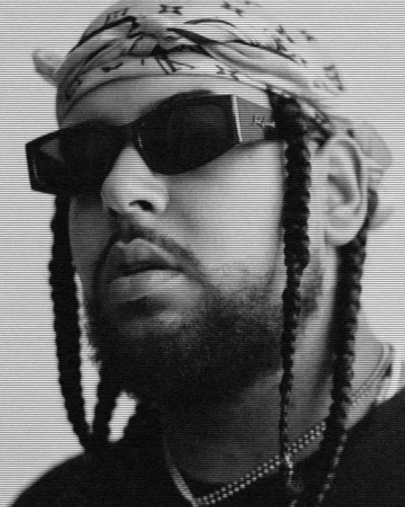 A man with long braids wearing sunglasses and a bandana.