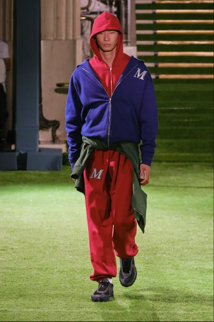 A man in red pants and blue jacket.