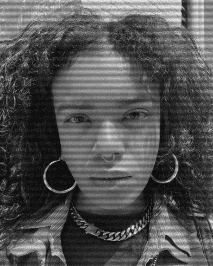 A black and white photo of a woman with curly hair.