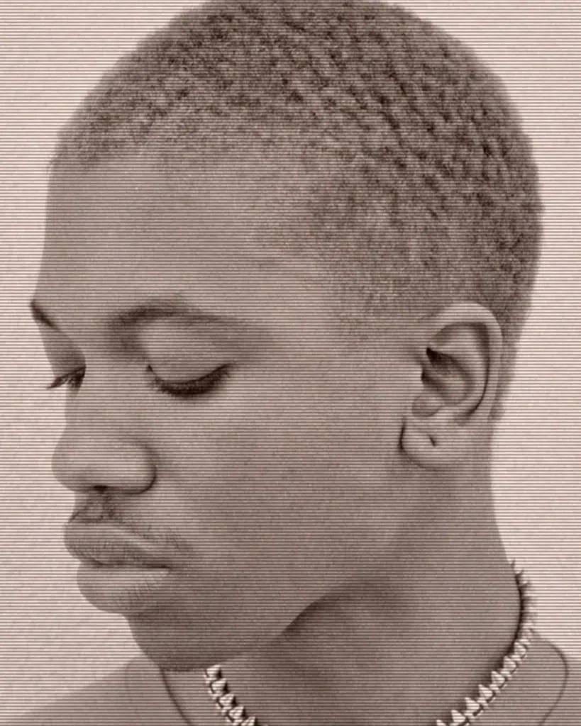 A young person with short hair is looking down.