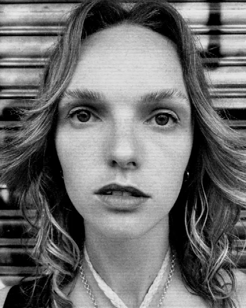 A black and white photo of a woman with long hair.