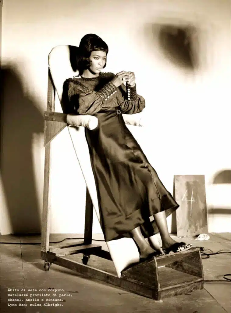 A woman sitting in a chair with her legs crossed.