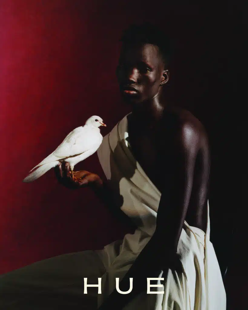 A man holding a white bird in his hand.