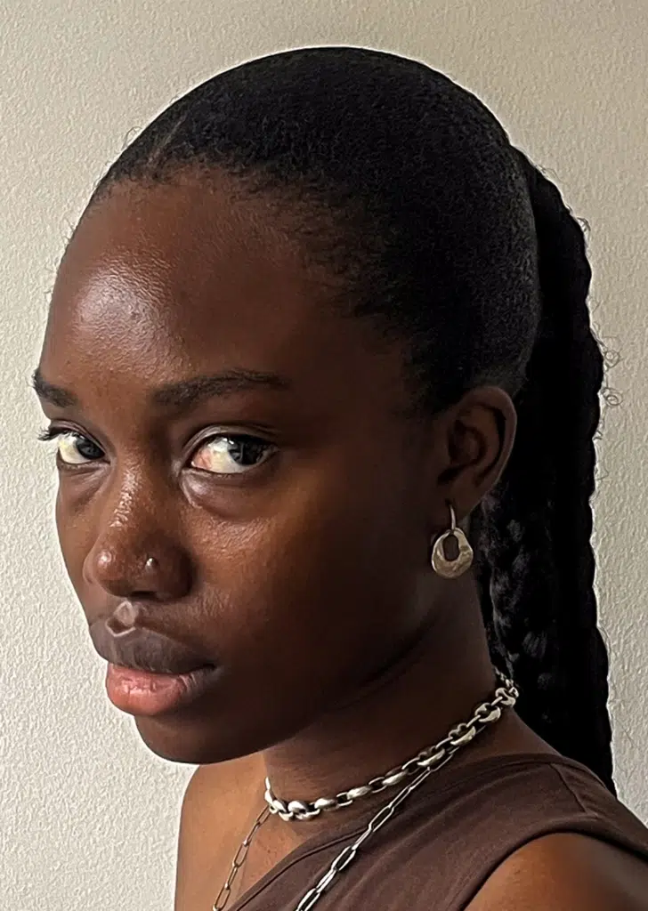 A woman with long hair and a necklace.