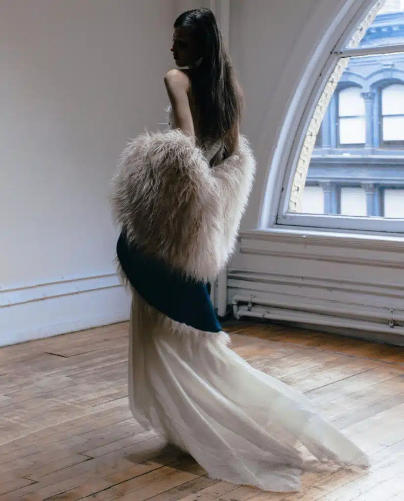 A woman in white dress standing on one foot.