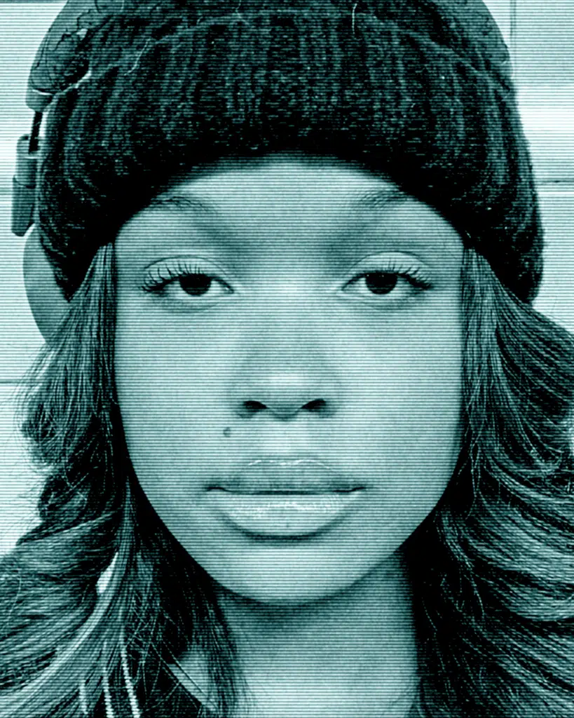 A young woman wearing a hat and looking at the camera.