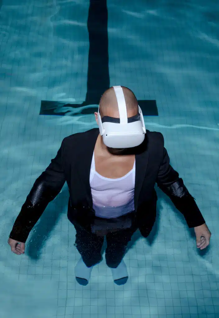 A man in the water wearing a suit and mask.